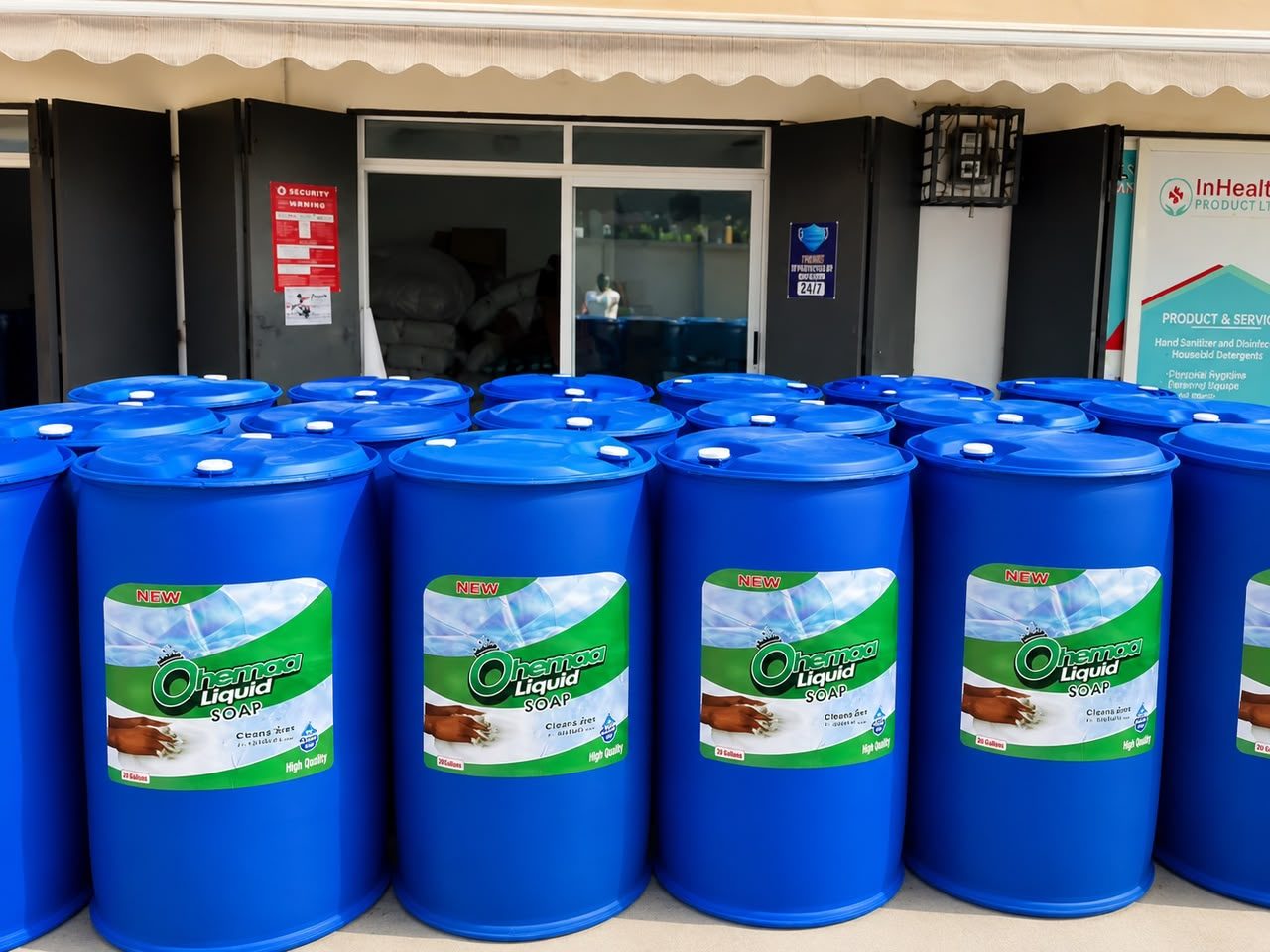 Rows of blue Ohemaa Liquid Soap drums outside the InHealth Product Line shop